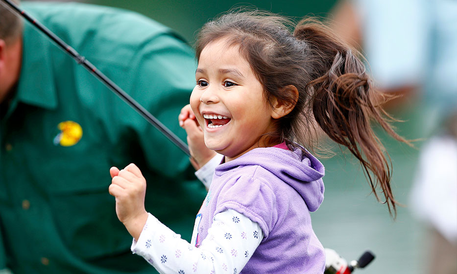 Young girl smiling happily during a Catch and Release event